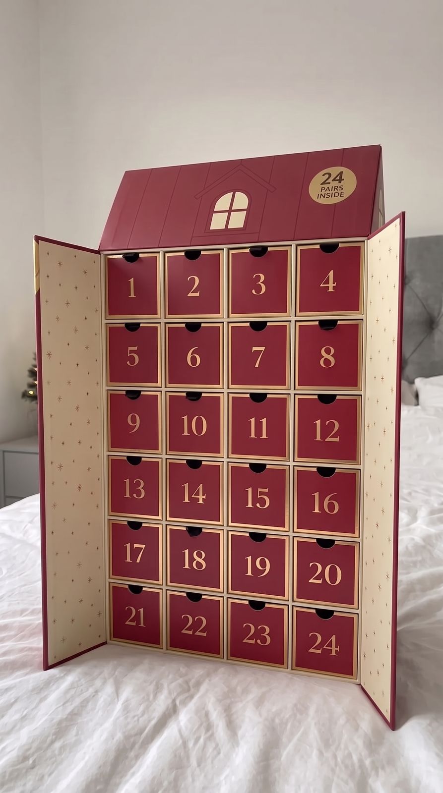 Open Naughty List advent calendar with 24 individually numbered compartments